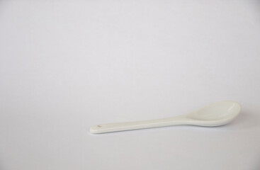 White teaspoon on a white background