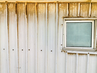 rusty and dusty abandoned refugee camp and it's window 