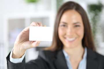 Happy executive shows credit card at the office