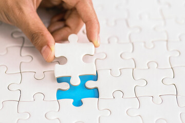 piece of Red green and gold jigsaw puzzle On the old wood And green background. teamwork concept. symbol of association and connection. business strategy.