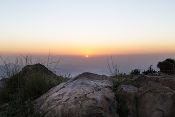 mountains rocks and sunrise in the background 