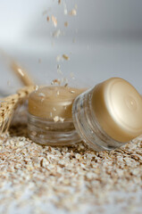 jars for cosmetics on a white background with wheat and oatmeal