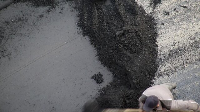 road workers lay asphalt with shovels and other special equipment, road repair, industry