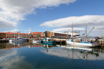 Fototapeta na wymiar Fishing boats moored at Victoria Dock in Hobart Port. Founded in 1804 as a penal colony, Hobart is Australia's second oldest capital city after Sydney. 