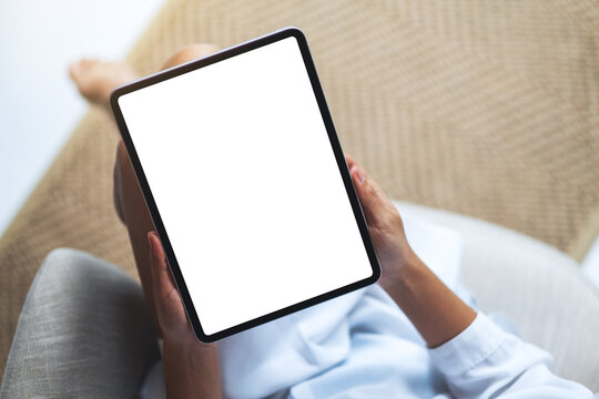 Top view mockup image of a woman holding black tablet pc with blank white desktop screen