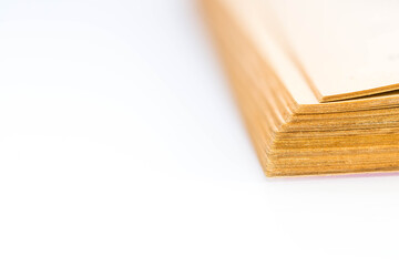 Old, aged, yellow book pages close up macro shot on white with copy space.