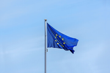 European flag with yellow stars for each member state on a blue background waving in the wind...