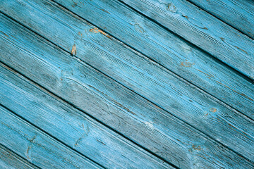 wood texture with old blue paint. The boards are located diagonally in the frame