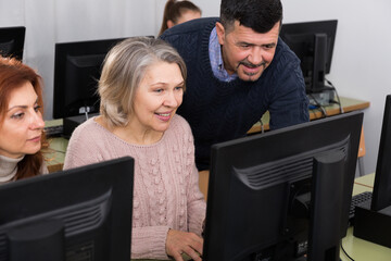 Male teacher helping mature women