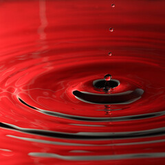 Macro of water drop in red color
