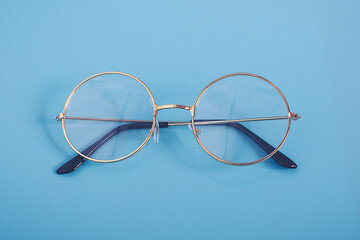 Stylish Gold black glasses isolated on blue vintage background