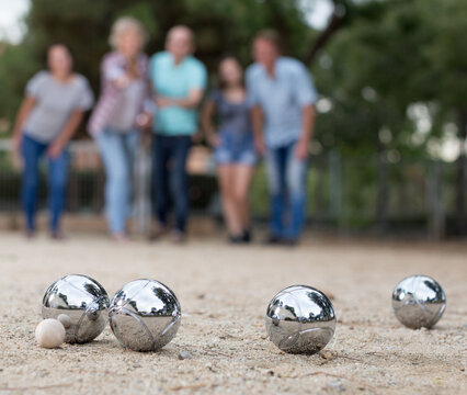 Image of people playing petanque on sand