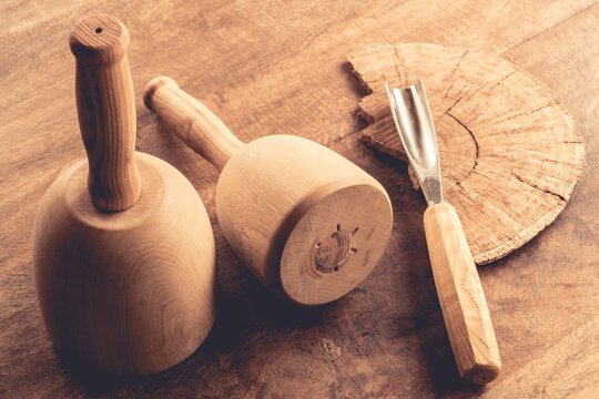 Still life of mallet and chisel carving tools on wooden table