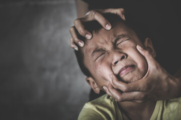 Scared child with an adult man's hand covering her face. stop abusing violence, human trafficking, stop violence against child, Stop child abuse, Child labor, Human rights violations.