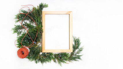 Christmas wooden frame juniper rope and red candle white background top view