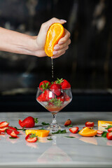Preparation homemade refreshing strawberry. Fruit juice with orange and strawberry.