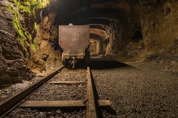 Old cart on rails in a mine