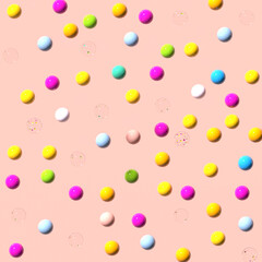 Multicolored plastic shiny balls on a pale pink pastel background. 3D render.