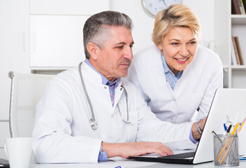 Doctor and nurse reading information