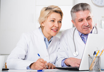 Doctor and nurse reading information