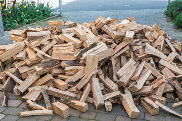 Messy pile of firewood on a drive, delivered for the winter stock