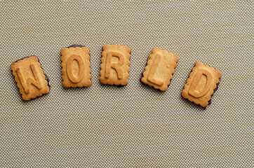 Word world. A single word is laid out in capital letters from cookies.