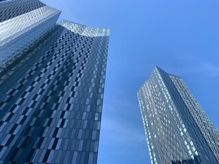Looking up at a modern skyscraper with a clear blue sky background. Taken in Manchester England. 