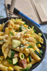Pasta with chicken and sweet corn in a bowl