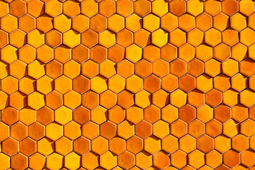 Bright orange sunlit hexagonal honeycomb tile background 