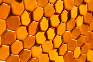 Bright orange sunlit hexagonal honeycomb tile background 