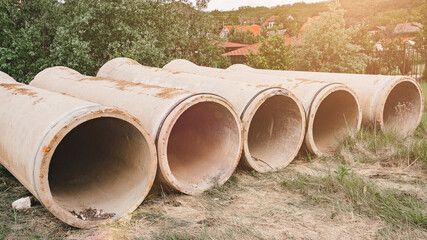 Concrete drainage pipes stacked on construction site