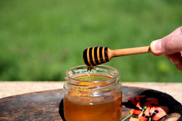honey in a glass jar with honey dipper
