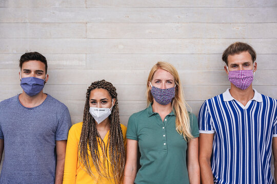 Young people wearing face protective masks for coronavirus prevention - Covid 19 lifestyle and millennial generation concept - Main focus on center faces