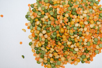 Background-multicolored varieties of legumes are scattered  on a white background. Concept of raw food and healthy nutrition.