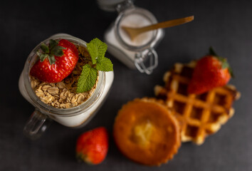 Vegetarian breakfast of yogurt with strawberry and muesli. Top view.