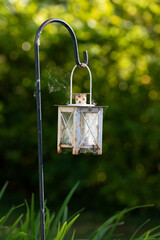 Rusty old garden lanter for a small candle with spiderweb