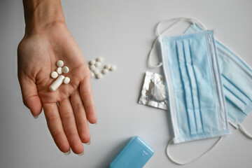 Hand holding pills against viruses and diseases,
bacteria and coronavirus