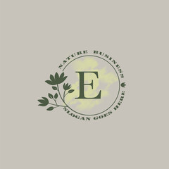 Circle nature tree E letter logo with green leaves in circle line shape for Initial business style with botanical leaf elements vector design.