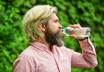 moisturize dry mouth. bearded mature man drinking some water. fresh and healthy water from bottle....