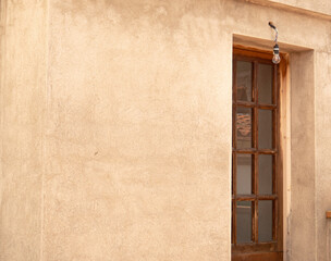 Brown wood door with little glass windows. Old building. terrace house.