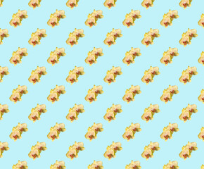 Seamless floral pattern. Yellow orchid with drops of water on a blue background.