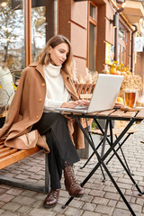 woman drinks hot tea in the autumn on the street