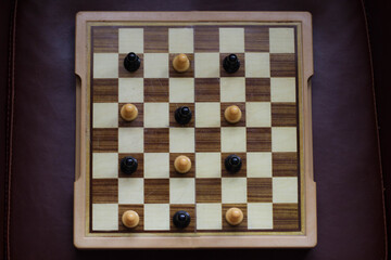Social distance between people to ensure protection against the coronavirus. Concept image with a chess board