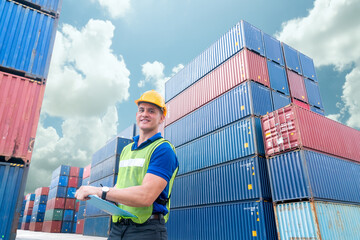 portrait of engineering man wearing uniform safety suit and helmet in industrial containers for...
