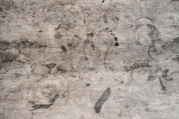 The texture of a wooden table with spots. Grey wood and round stains from drinks glasses.