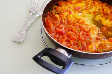 menemen dinner made with tomatoes and eggs in the pan for breakfast,