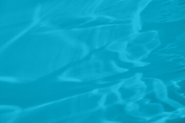 Trendy mint blue colored low contrast abstract background with light and shadows caustic effect. Light passes through a glass. Water background. 2021 year color trend