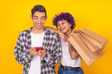 young couple with shopping bags and mobile phone