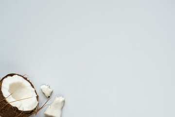 top view of fresh tasty coconut half and cracked pieces on white background