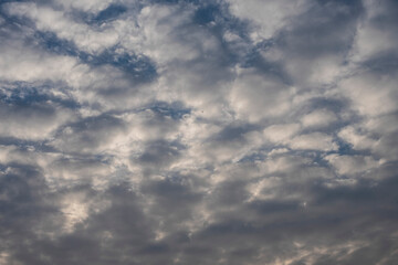 Beautiful clouds roaming in the red and bluish sky during sunset in the afternoon. Indian landscape and sky.